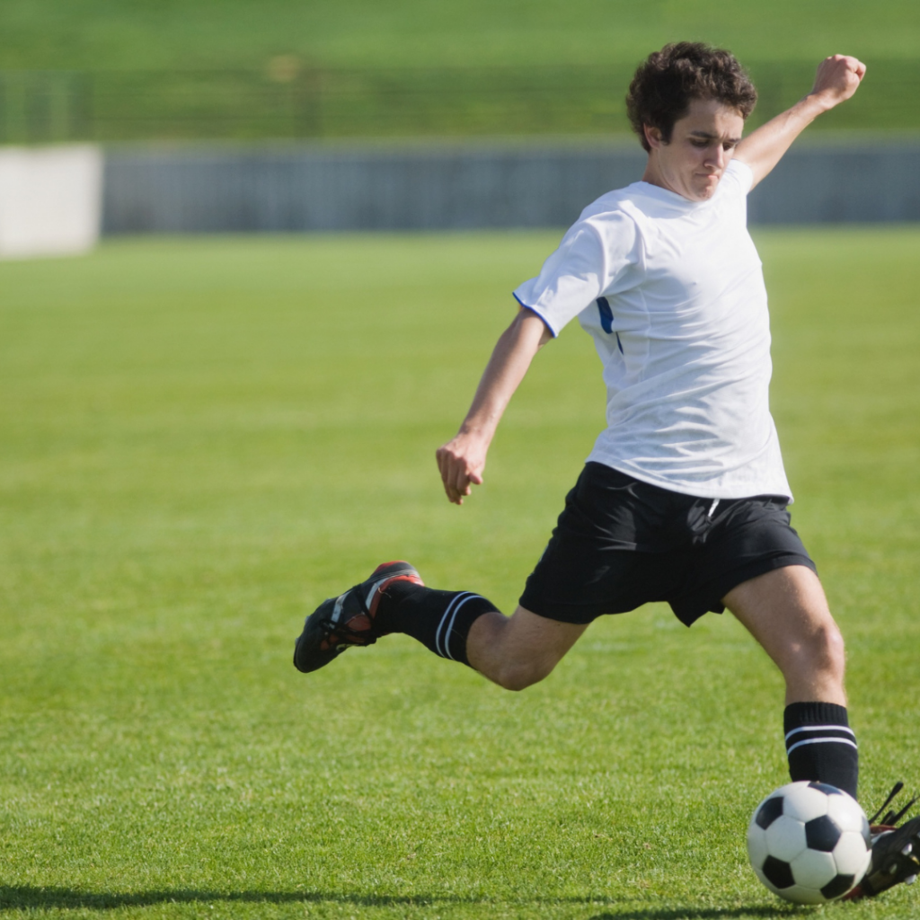 young boy playing fooftball