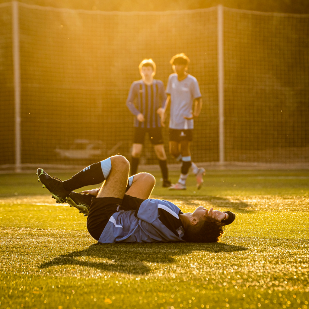football suffering a sport injury on the field receiving expert care from a sport doctor Bangalore  